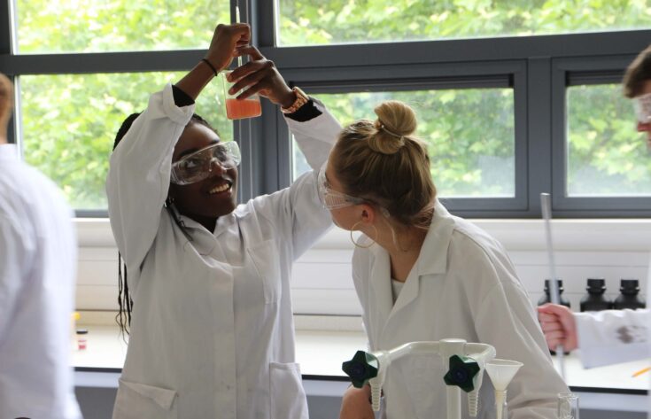 Chemistry students performing experiments in a lab