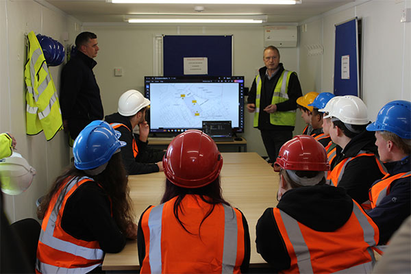 Aquinas students learning about the new build in one of the sites offices.