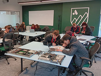 Photograph of a group of students working on server hardware