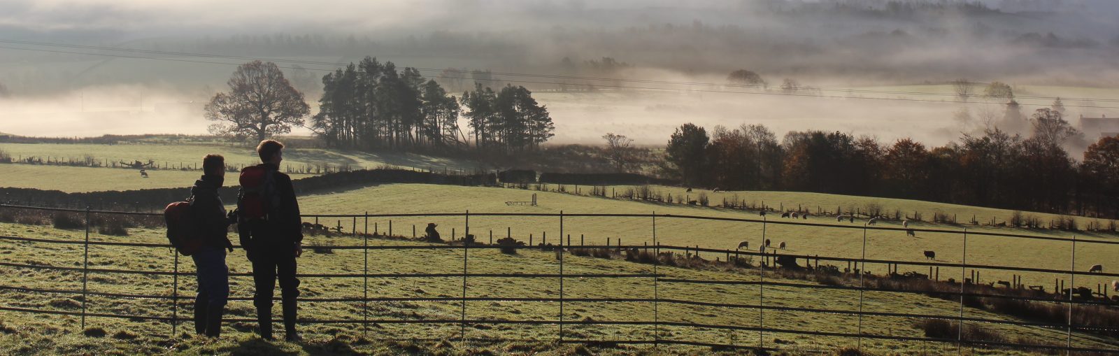 Photograph of two students looking out into the countryside.