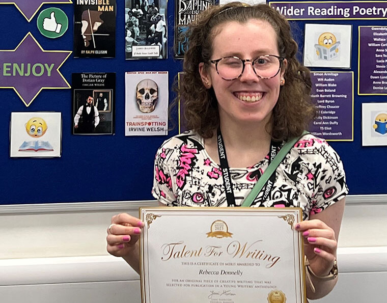 Photograph of Becca Donnelly holding up her award