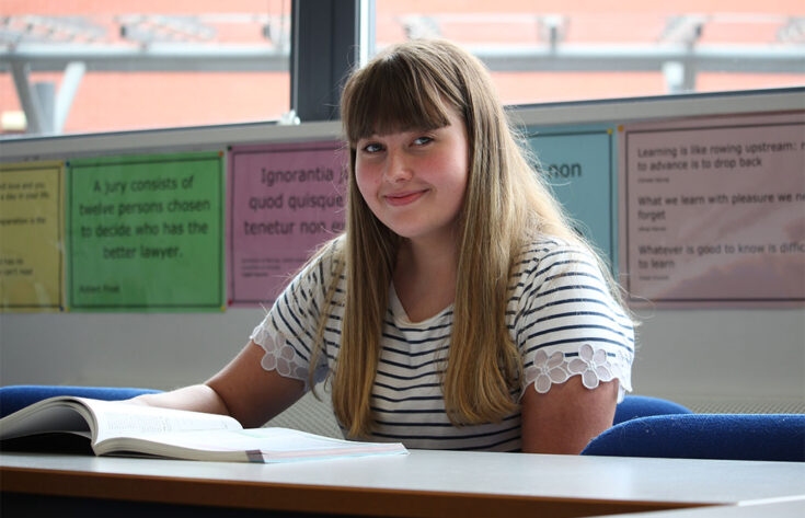 Photograph of an Applied Law student with an open book