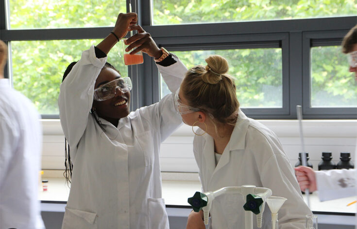 Photograph of chemistry students performing an experiment