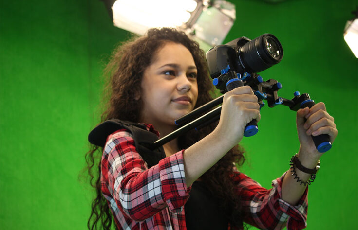 Photograph of a media student holding a handheld rig