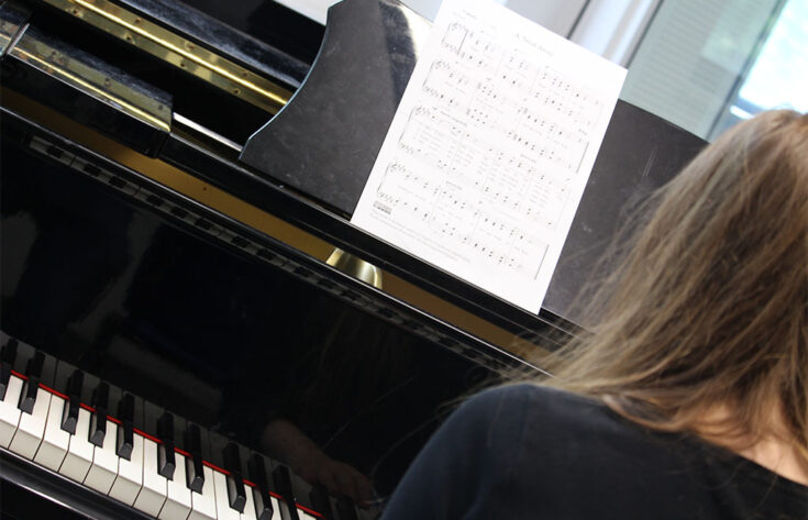 Photograph of a music student playing the piano