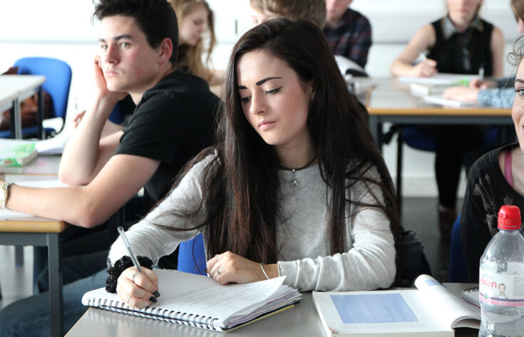 Photograph of a student studying in a classroom