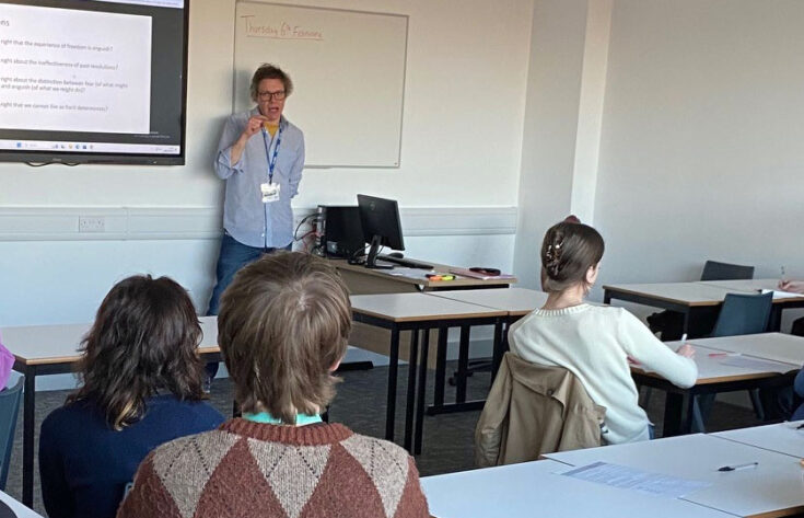 Photograph of Dr Joel Smith giving a talk to students