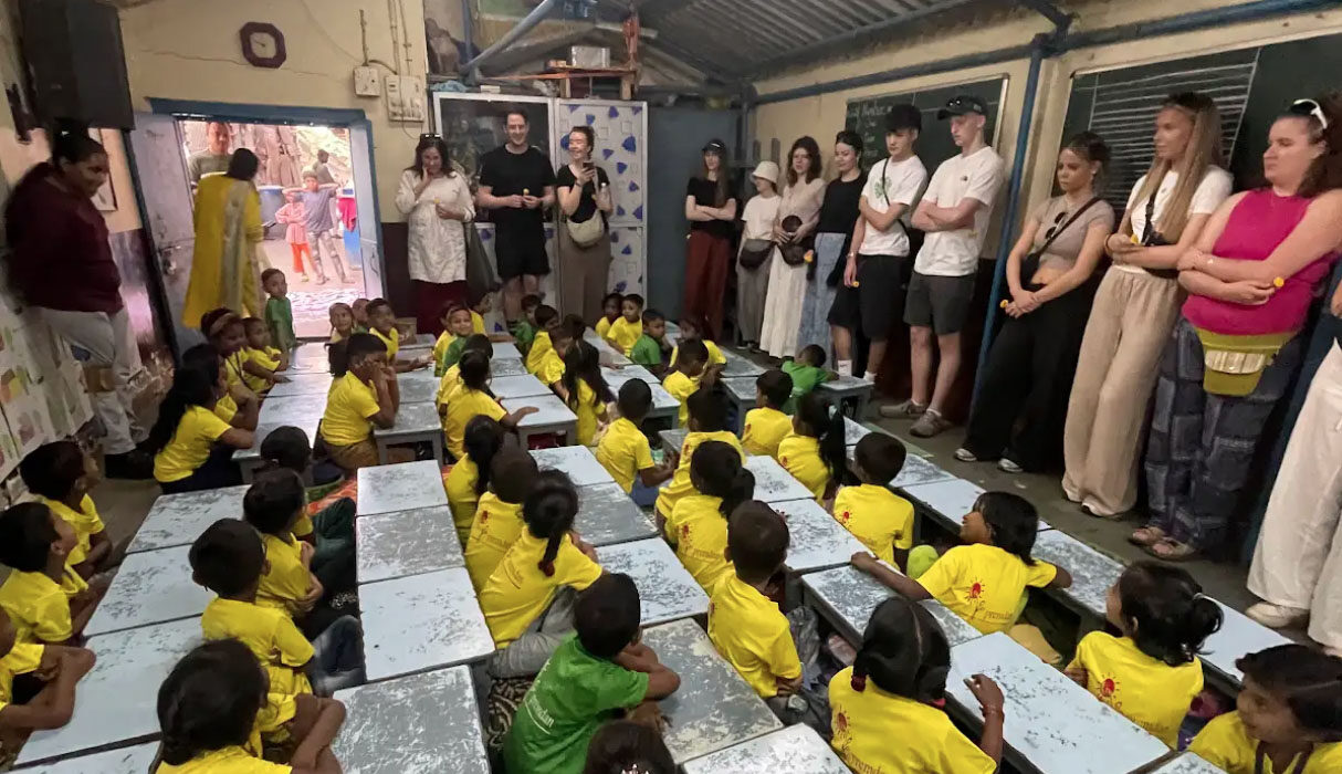 Photograph of pupils and Aquinas students in a class room and Premdan